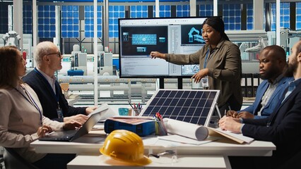 Engineering team in photovoltaics plant improving solar cells efficiency. Solar panels factory...