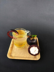 mangosteen fruit (Garcinia mangostana) served with a drink made from its peel extract
