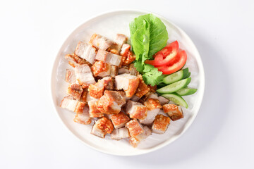 Crispy pork belly on white plate and dipping sauce on a white background