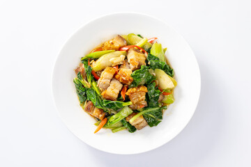 Stir fried kale with crispy pork in oyster sauce on white plate
