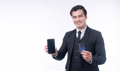 Smiling handsome businessman showing blank smartphone screen and credit card for mobile banking. Happy professional man recommending fintech app isolated on white background.