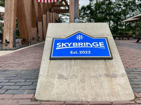 Boyne Falls, Michigan, USA, June 24, 2025 : Entrance sign to the Skybridge Suspension Bridge at Boyne Mountain in Northern Michigan. This is the world's longest timber-towered suspension bridge.
