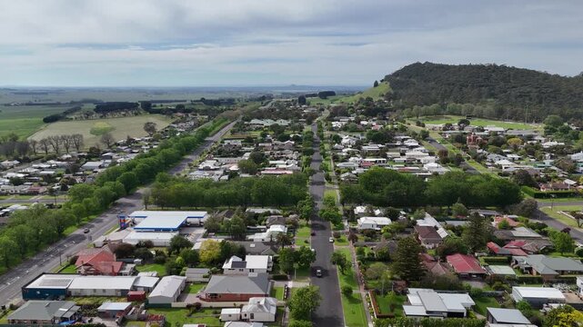 Aerial view of Camperdown, Victoria, with Mount Leura rising behind the town’s straight, tree-lined streets. An orderly regional township planning and the surrounding volcanic landscape in Australia.