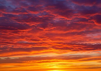 Fiery sunset sky vibrant colors of red orange and yellow across clouds