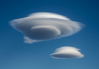 Unusual cloud formations against a clear blue sky background with natural light