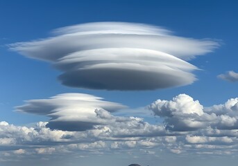 Unusual lenticular clouds in blue sky formation atmospheric natural phenomenon