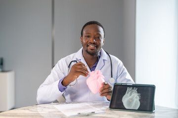 Doctors discussing cardiology case using heart model and digital scan, cardiovascular health, medical training and heart anatomy explanation, modern medical training team education, heart disease