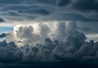 Dramatic cloudscape with dark gray storm clouds and sunlight peeking through