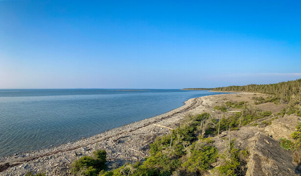 Coastal Cliff, Layered Rock Formations and Boreal Forest at English Head on a Sunny Day in Anticosti, Quebec, Canda