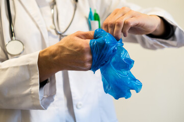 Doctor with Crumpled Used Glove in Hand, Emphasis on Safe Disposal and Waste Management