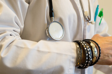 Doctor Wearing Multiple Bracelets and Stethoscope, Focus on Jewelry and Improper Medical Hygiene