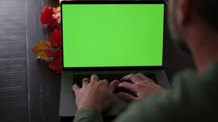 Mature bearded man working remotely on customizable green screen laptop- Perfect for inserting your own app, dashboard, video call, charts, or website