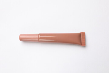 Beautiful nude lip gloss on white background, top view