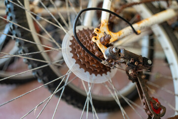 Detailed view of rusty bicycle cassette, derailleur and chain on an old bike in workshop