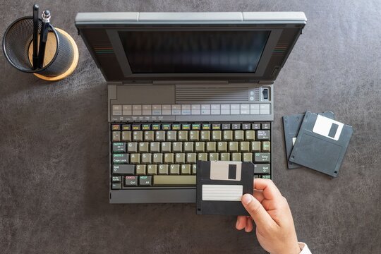 hands of a man working with floppy disks