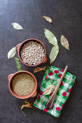 raw lentils and beans in clay pots