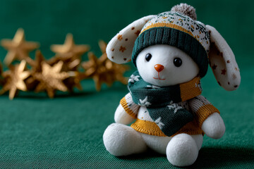 Cute bunny toy wearing winter outfit with golden stars