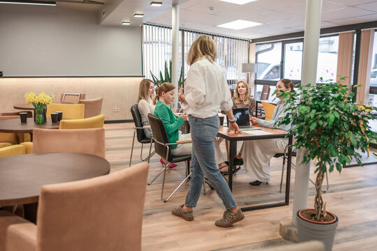 Business women meeting collaborating on laptop in modern office space cafe - Powered by Adobe