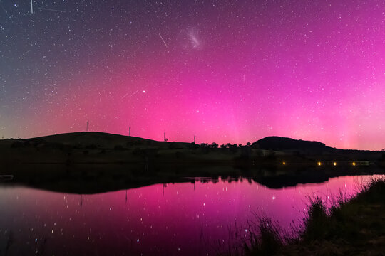 Aurora Australis display lights up the sky in pinks over the dam - Powered by Adobe