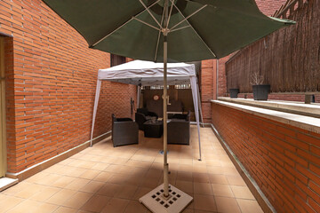 Obraz premium Covered terrace with a bioclimatic pergola, transparent wind curtains, and rattan furniture with waterproof cushions