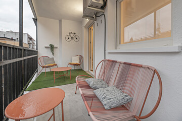 Obraz premium Urban garden terrace with artificial turf, herb planters, and an automated irrigation system