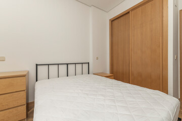 Modern master bedroom with a king-size bed featuring a gray velvet upholstered headboard, floating nightstands, and LED reading lamps.