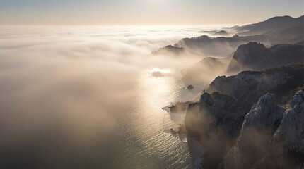 A radiant sun shines over the ocean, casting light on the mountains in the distance, creating a serene landscape