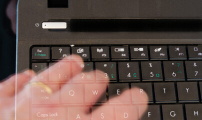Ghost hand touching computer keyboard