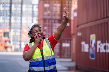 Construction worker directing operations at shipping yard industrial environment professional action shot