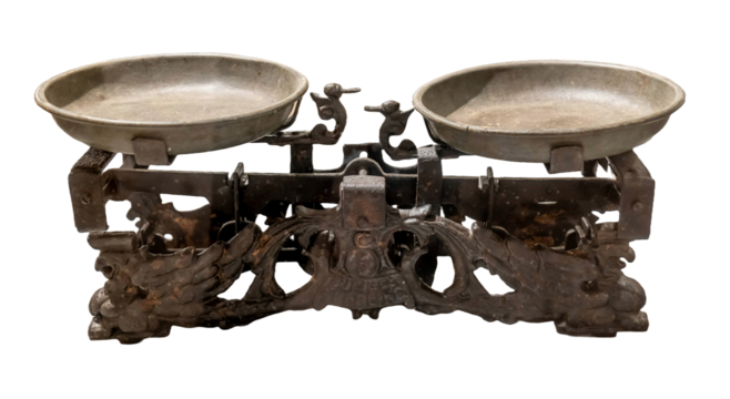 Antique cast iron weighing scales with two metal pans isolated on white background, cut out. Old rusty ornamental balance weight measurement tool, retro vintage kitchen object, shopping trade symbol