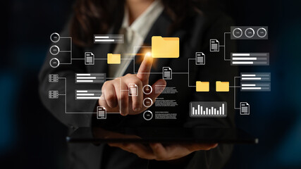 A businesswoman engages with a digital interface, showcasing modern technology and data interaction. The image highlights innovation in information management and user experience. Gantry