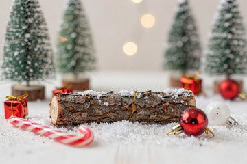 Winter wonderland scene with rustic log and festive decorations, perfect for holiday season greetings and cozy Christmas celebrations
