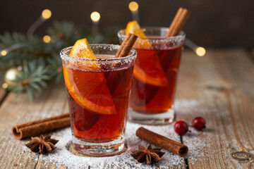 Aromatic mulled wine with orange and cinnamon, served in elegant glasses, creating a warm and festive atmosphere perfect for cozy winter holiday celebrations