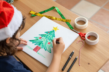 Cozy holiday crafting A child's creative joy as they draw a festive Christmas tree, creating heartwarming seasonal art