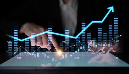 A business analyst engages with data trends on a tablet, highlighting financial graphs and statistics in a sleek modern workspace focused on growth and analysis. Scalp