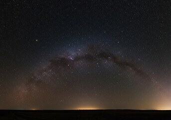Fototapeta premium A breathtaking panoramic view of the deep dark night sky filled with countless brilliant stars and distant galaxies above the horizon ,atmosphere ,nature ,exploration
