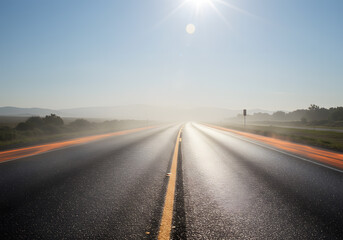 Naklejka premium Empty highway through foggy landscape