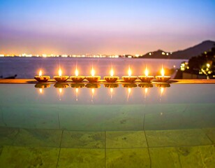 Fototapeta premium Serene infinity pool scene with glowing oil lamps reflecting across tranquil water at twilight