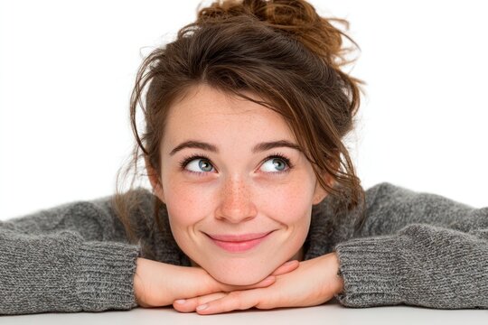 Contemplative Portrait: A young woman with a thoughtful expression gazes upwards, her eyes filled with curiosity, capturing a moment of introspection and day dreaming.