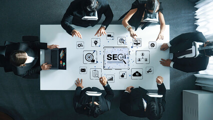 A business team collaborates innovatively using virtual reality headsets to discuss SEO strategies in a modern workspace, emphasizing technology and teamwork. Trope