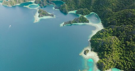 Beautiful limestone rocks in Lagoons in Coron. Tropical Islands with blue sea and boats. Palawan. Philippines. - Powered by Adobe
