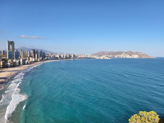 beach city scene, bright seaside urban landscape, sunshine illuminated city and beach views