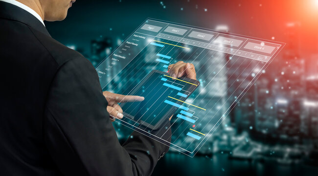 A businessman interacts with a futuristic touchscreen display showcasing graphs and charts for data analysis against a vibrant city skyline at night. Tessel - Powered by Adobe