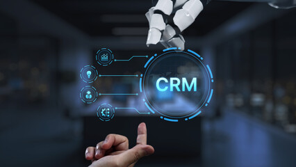 A robotic hand interacts with a digital CRM interface, showcasing the fusion of advanced technology and business innovation in a modern office environment. Synapse