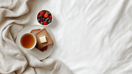 Breakfast spread on white linen with toast, butter, berries, and tea. Ideal for food blogs, menus, and culinary designs.