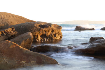 water flowing over rocks by the sea