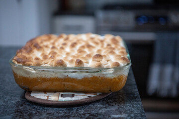 Homemade sweet potato casserole with marshmallows fresh from the oven for Thanksgiving dinner.