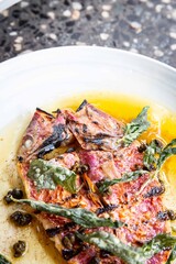 Grilled fish with herbs, restaurant plates