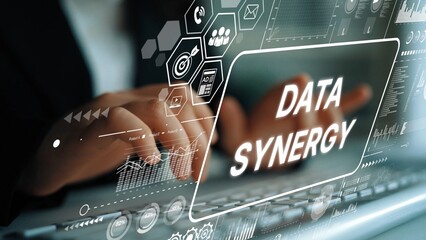 Hands of a Business Professional Engaged in Data Synergy Analysis with Digital Graphics and...