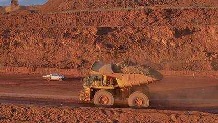 Mining dump truck in the process of transporting minerals from the bottom of the mine to the open pit